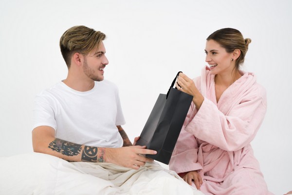 man and woman with black shopping bag