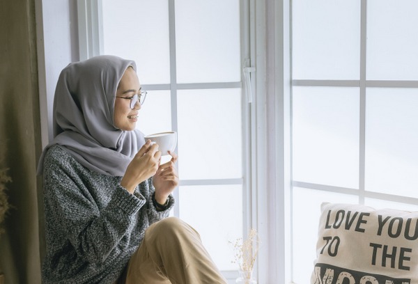 self care woman wearing hijab in window