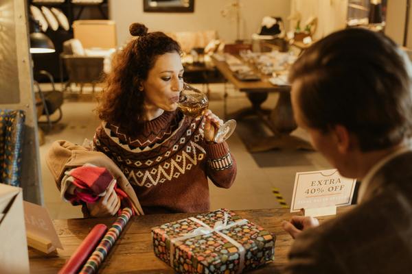woman with christmas present drinking wine