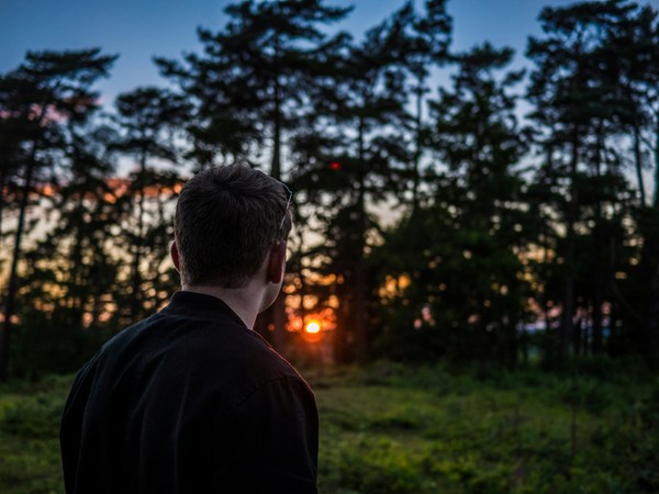 man watching sunset